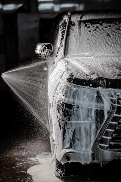 A car covered in foam during a professional mobile detail